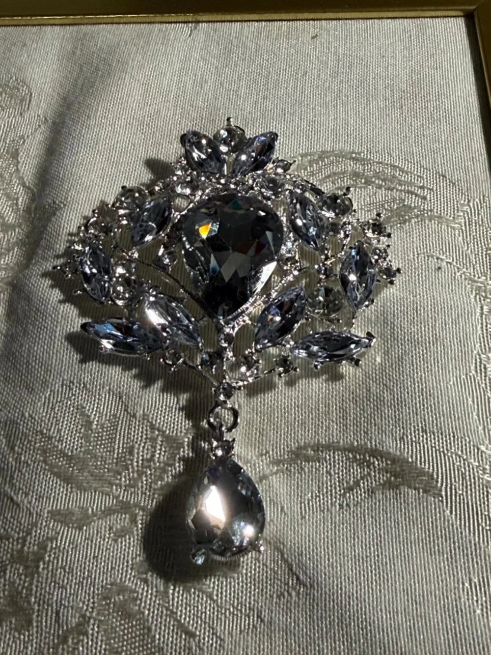 Silver-Tone Rhinestone Floral Brooch with Teardrop Dangle